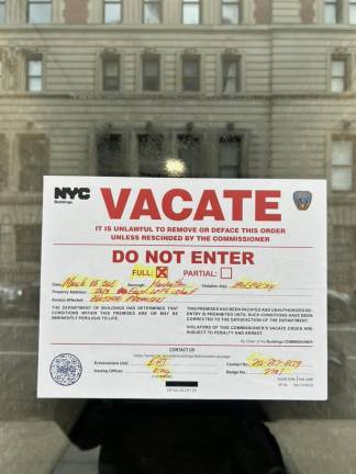 Notice to vacate posted on front door of building at 243 E. 18th St.