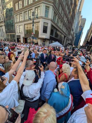 Szymon Hołownia crowded by photographers at the Pulaski Day Parade, Oct. 5, 2025.
