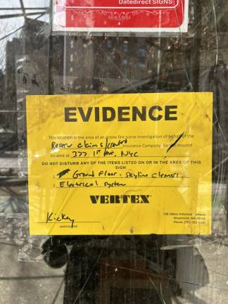 Notice posted outside the front of the building informing tenants of a pending fire investigation by the insurer.
