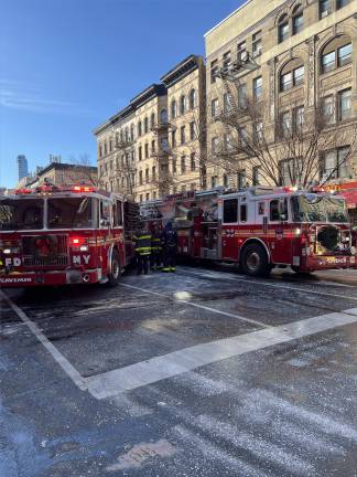 Firetrucks shut down part of Amsterdam Ave. to deal with the blaze.