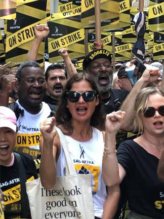 Jill Hennessy (center) was among the many boisterous marchers in the SAG-AFTRA contingent. The union has been on strike for over 110 days, shutting down movie and tv production. Photo: Keith J. Kelly