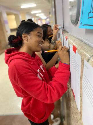 Students in a school hallway gallery where all final stories were displayed. Photo courtesy of Ilana Gatoff