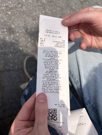 A sightseeing cruise ticket shown by two visitors from Idaho contains no printed price.