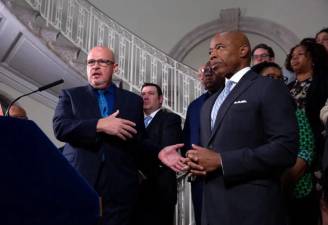 In happier times, United Federation of Teachers president Michael Mulgrew and Mayor Eric Adams at City Hall after the city reached a new contract agreement with the public school teacher’s union in June. Now the union is suing to halt budget cuts. Photo: Ben Fractenberg, THE CITY