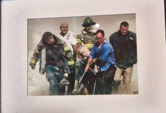 On display at the Fire Museum is the photo shot by Reuters photographer Shannon Stapleton showing the body of FDNY chaplain Father Mychal Judge carried by firefighters Christian Vaughn and Zachary Vause; NYPD Lt. William Cosgrove; Kevin Allen of the Office of Emergency Management and Goldman Sachs civilian and West Point graduate John Maguire.