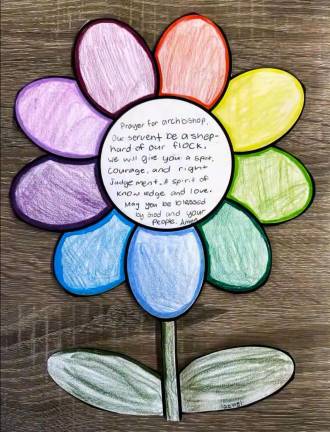 Transfiguration School students recently made paper flowers welcoming Archbishop Hicks.