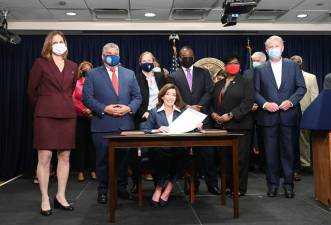 New York Governor Kathy Hochul, flanked by Lieutenant Governor Brian Benjamin, progressive advocates and state Democratic leaders on Friday, signed The Less Is More Act, which will end the practice of sending people to jail as they await hearings over alleged technical parole violations. Photo: Kevin P. Coughlin / Office of the Governor