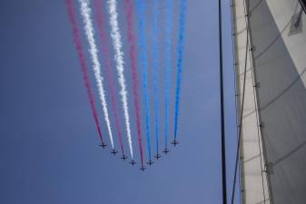 BAE Hawk jets flying over the Hudson River and leaving red, white, and blue vapor trails in the shape of the U.S. flag as part of the Sail4th 250 celebrations.
