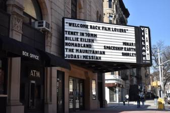 The Village East by Angelika’s marquee reads “Welcome Back Film Lovers,” as people pass by on March 8. Photo: Leah Foreman