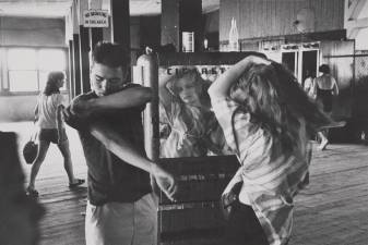 Kathy Fixing Her Hair in a Cigarette Machine Mirror, Coney Island, 1959. From Series: “Brooklyn Gang”