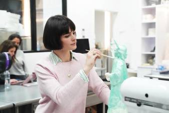 Ashley Holt, the owner of Sugar Monster, finishes her chocolate Statue of Liberty in NY Cake's kitchen.