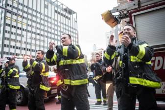 Firefighters applaud medical staff at NYC Health + Hospitals/Bellevue on Friday, April 10, 2020 during a visit by Mayor Bill de Blasio and First Lady to thank health workers.