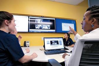 Kellie Bryant (right) with nursing students at the simulation center at Columbia University.