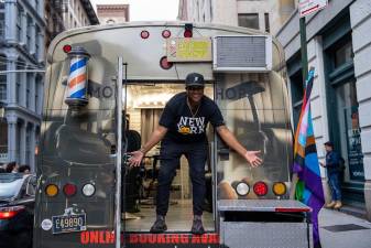 Meek Young, 37, poses at her van that was converted into a mobile barbershop. Photo: Nathan Morris