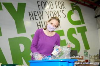 Jennifer McLean repacking food at City Harvest’s Food Rescue Facility. Photo: Lori Cannava