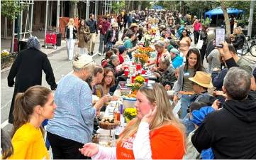 Meeting and greeting is a big part of the Longest Table in Chelsea, now in its fourth year. This year, a record setting 2,000 people turned out.