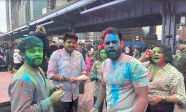 Hair, faces and clothes all covered with powder at the March 7 celebration of the Holi Festival at the South Street Seaport.
