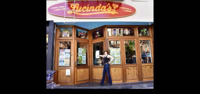 Karen Rempel points the way to Lucinda’s honky-tonk juke joint at 169 Avenue A.