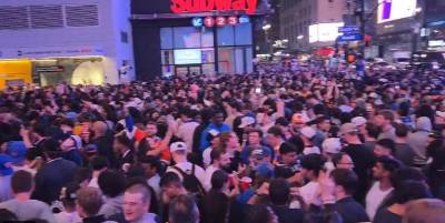 Jubilant Knicks fans go wild in the streets surrounding Madison Square Garden after the blowout series clinching Game 6 victory over the defending NBA champions Boston Celtics on May 16. Despite knocking over police barriers, taking over Seventh Ave and climbing atop vehicles and street lights, police report there were no arrests.