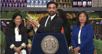Mayor Zohran Mamdani holding a pair of plantains at a press conference on July 27 regarding city-owned grocery stores.