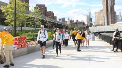 Volunteers hand out snacks to help participants refuel along the 32 route of the Great Saunter around Manhattan.