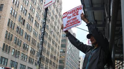 Protestors held up posters resembling no parking signs.