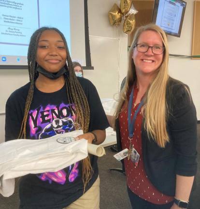 London Francis receiving her white coat from MedAchieve program advisor Dr. Stacey Fanning. Photo: Barbara Franklin