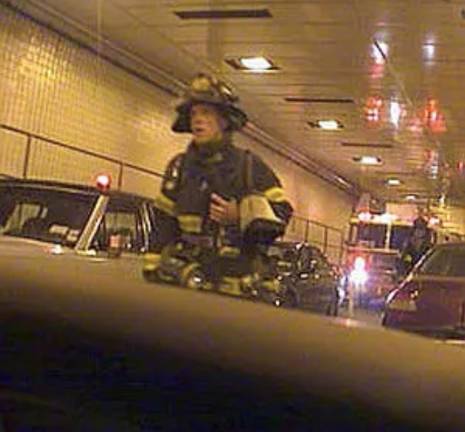 9/11 Moring: FDNY Firefighter Gary Box of Squad 1 in Park Slope, Brooklyn—the same unit as Stephen Siller—making his way on foot through the Battery Tunnel as the Squad 1 truck waits in traffic behind him.