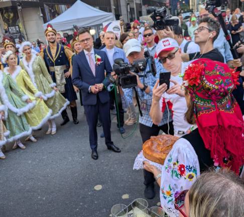 Speaker of the Sejm, Poland’s Lower House of Parliament, Szymon Hołownia (in pink tie) during the bread-giving ceremony.
