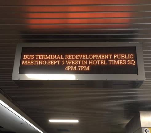 A sign inside the bus terminal informs the public about the hearing.