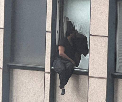 A suicidal man who was wanted by the FBI broke the window of his high rise apartment on West 56th after the FBI raided it and was dangling from the 31st floor before being rescued by an elite NYPD ESU team. <b>Photo: Twitter@ImMeme)</b>