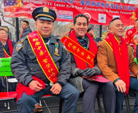 On the grandstand were Captain Michael Lam (left), commanding officer of the 5th precint, which covers Chinatown and city council member Christopher Marte (middle).