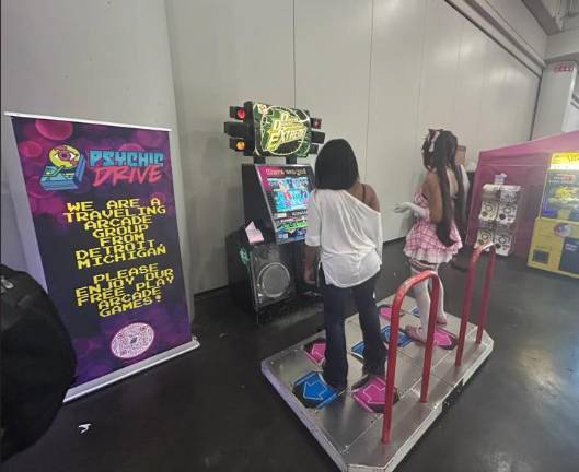 Players step onto the Dance Dance Revolutin Extreme machine.