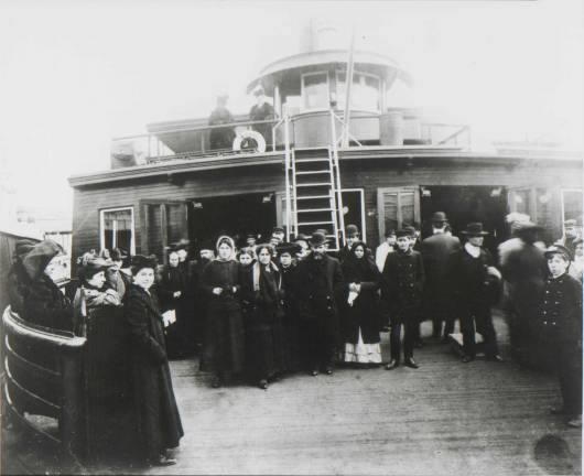 Volunteers for NCJW NY assisted immigrants coming off boats to Ellis Island.