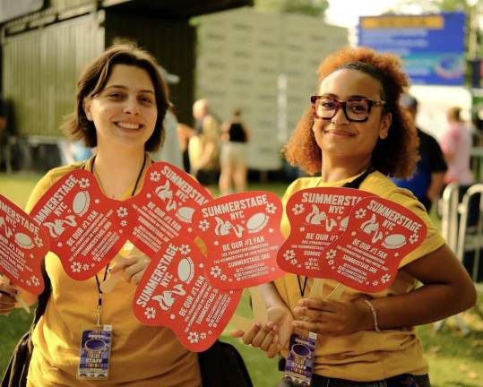 Summer Stage event workers with sign paddles to guide you.