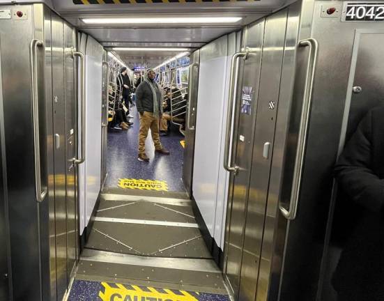 Looking down the aisle on the new R211T trainset, you can see through this subway car to the next one, and then the next one after that. This passageway has interior panels and is noted to be a “hard shell” with a more narrow passeway between cars. Photo: Ralph Spielman