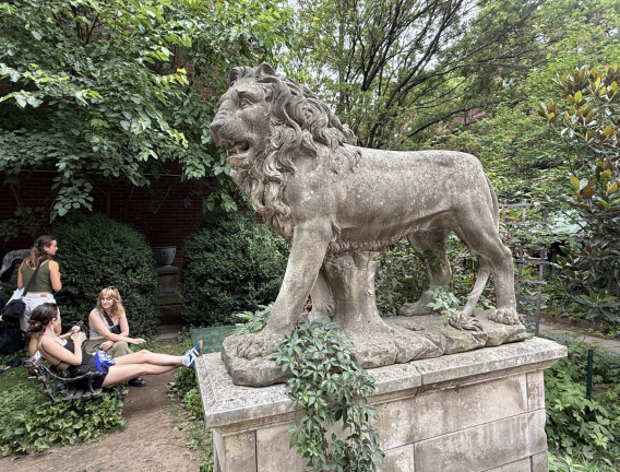 Relaxing near a lion statue on July 20 inside Elizabeth St. Garden.