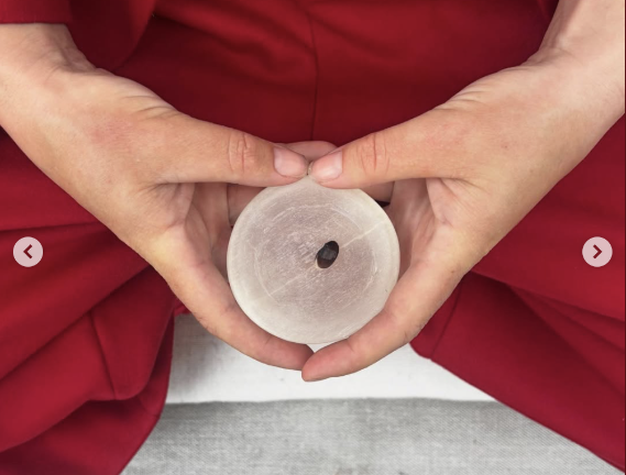 MacEwan held a black turtle bean during their red-themed meditation on pride.
