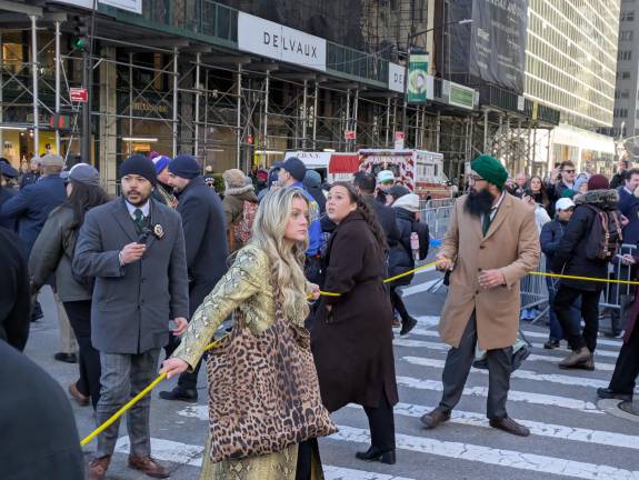 Mayoral staff members holding the yellow cordon of inaccessabilty, a marked changed from Mayor Eric Adams protocol, which allowed closer access.