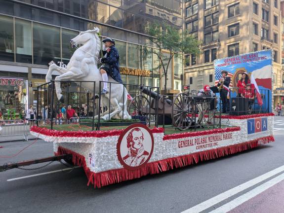 “General Pulaski” rides a white cavalry horse.
