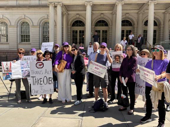 Plaintiffs, advocates and supporters gather outside City Hall on June 25 after announcing a lawsuit challenging Mayor Zohran Mamdani’s e-bike enforcement policy. They want tougher enforcement.