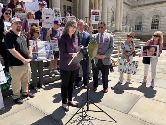 During a June 25 rally outside City Hall, Rita Rosencranz describes the injuries she suffered after being struck by a Citi Bike rider in Riverside Park.