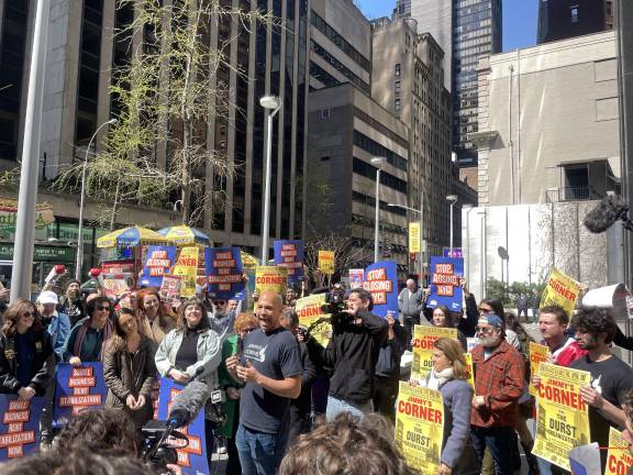 Jimmy’s Corner owner Adam Glenn (center-right), who inherited the dive bar from his late boxing legend father, rallied against a planned eviction of his business by the Durst Organization on April 10.