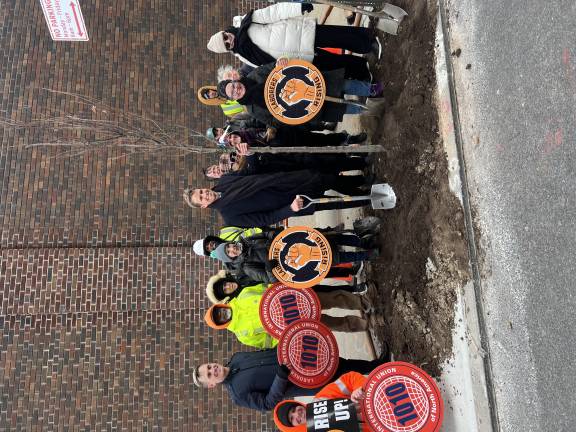City Council Member Erik Bottcher (center) poses with a sapling, the 1,000th he’s planted locally during his time representing Chelsea and Hell’s Kitchen. He was joined by local laborers, allies, and Parks Dept. reps.