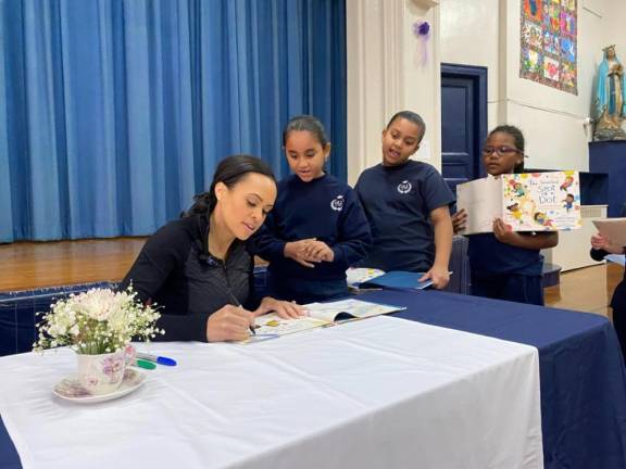 Students from Our Lady of Lourdes line up for autographs from ABC News correspondent Linsey Davis who read from her new kids book as the Archdiocese celebrated Catholic School Week. Photo: Page Turners