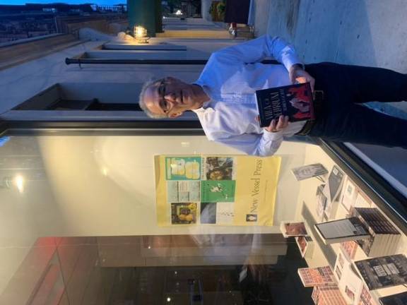 New Vessel Press Cofounder and Publisher Michael Wise in front of pop-up display. Photo courtesy of New Vessel Press