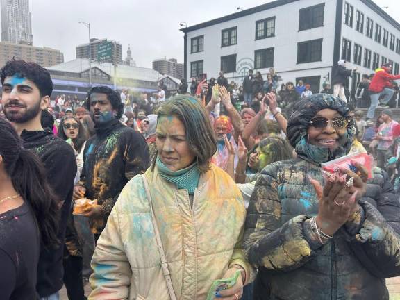 Participants wear old clothes, often white, because by the end they will be covered with a rainbow of colored powder.