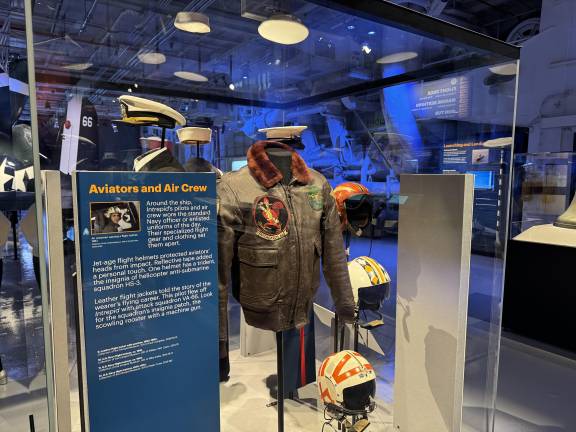 Flight suits, helmets, and dress uniforms are among the new artifacts of former crew members on display at the new exhibit.