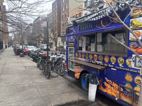 A halal truck parked on E. 11th St. is completely boxed in by e-bikes and scooters.