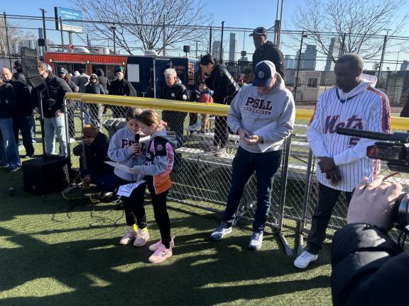 Harper and Olivia lead the crowd in reciting the Little League pledge on opening day.